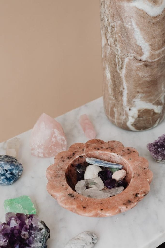 crystals-over-a-marble-top-table-6825320 Aesthetic arrangement of natural crystals and gemstones on a marble surface for decor and wellness.