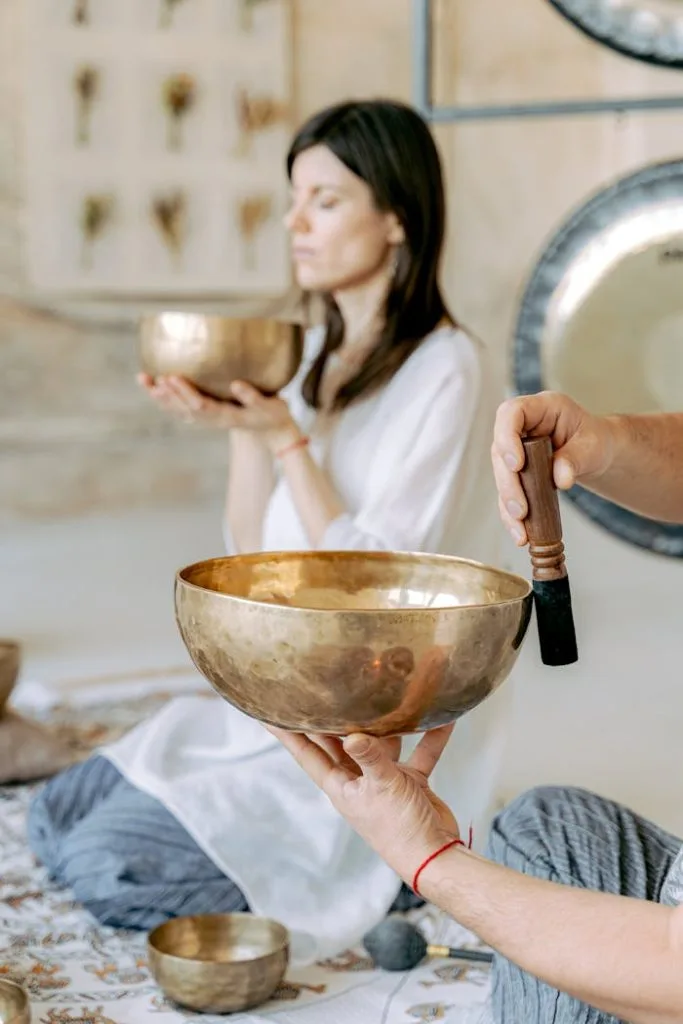 person-holding-a-tibetan-singing-bowl-6252095 A serene meditation session with singing bowls, promoting peace and healing.
